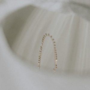 gold bracelet on white textile