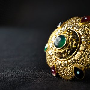 gold and blue ring on black textile