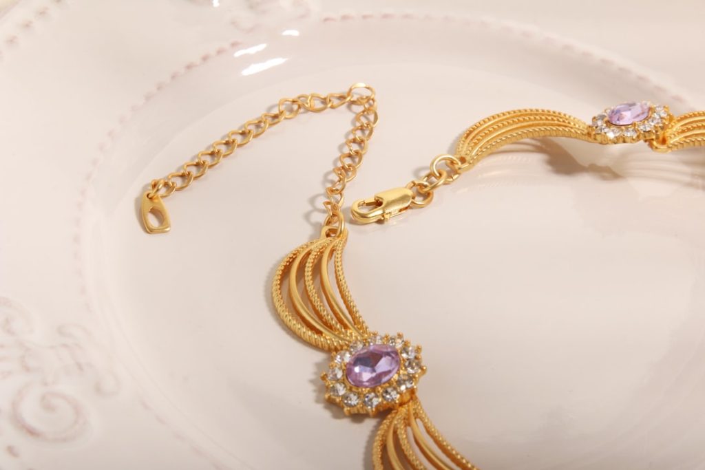 a gold chain with a diamond pendant