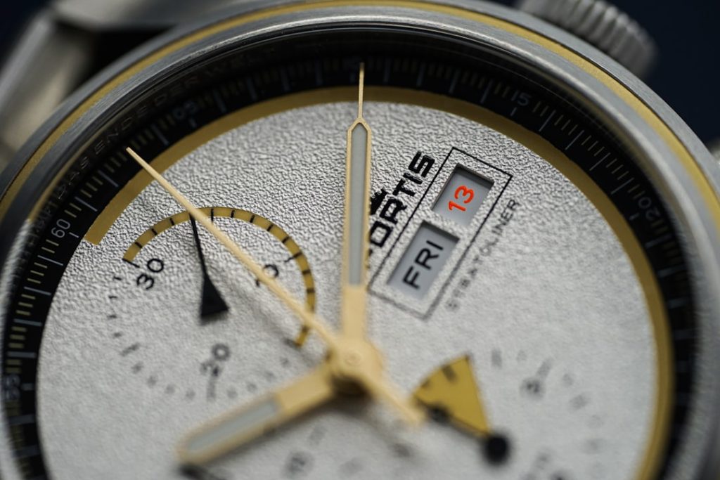 a close up of a watch face with a black background