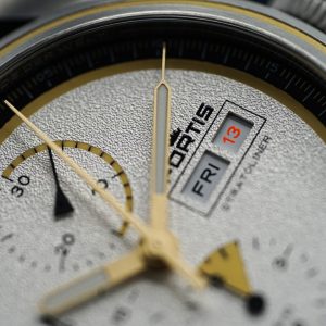 a close up of a watch face with a black background