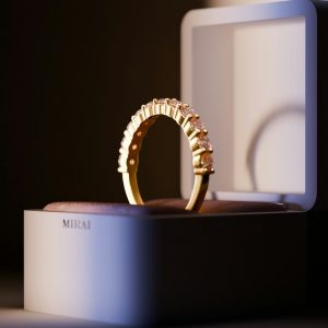 A gold ring sitting on top of a white box