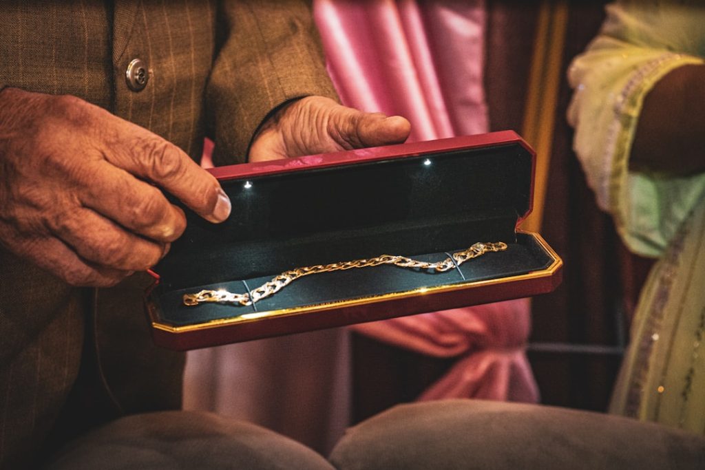 A man holding a box with a chain on it