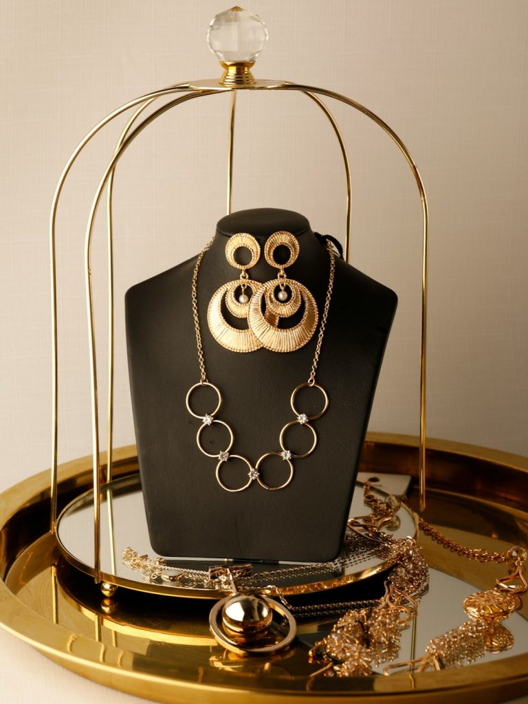 A display of jewelry on a gold tray