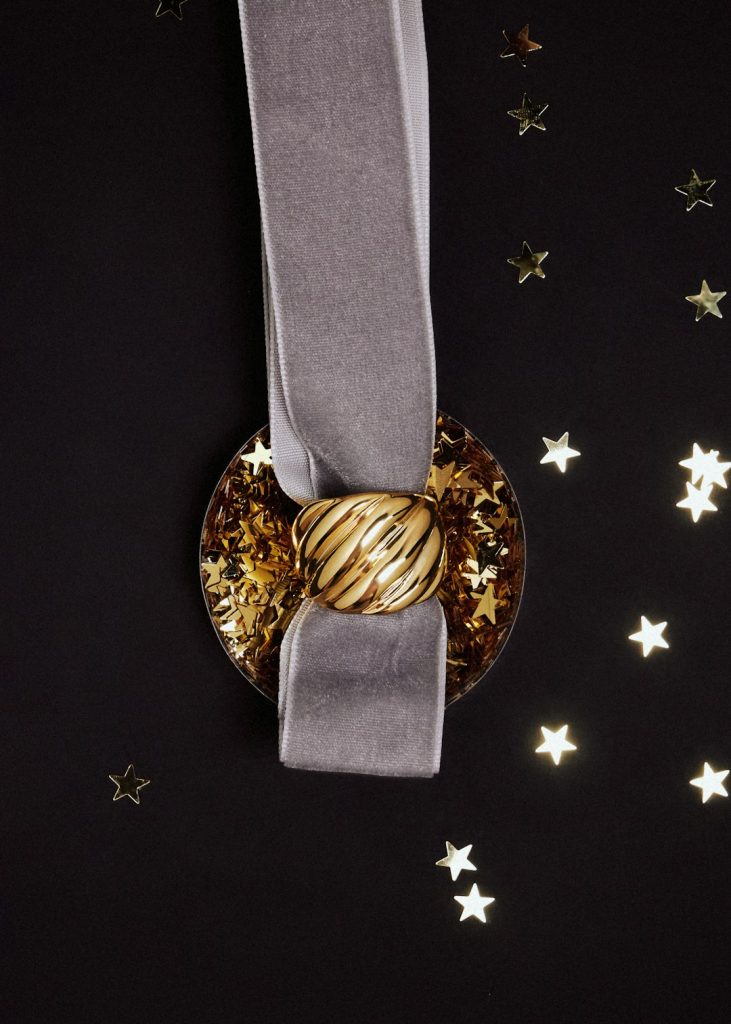 A plate with a gold and silver decoration on it
