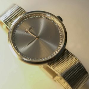 A silver watch with a mesh band