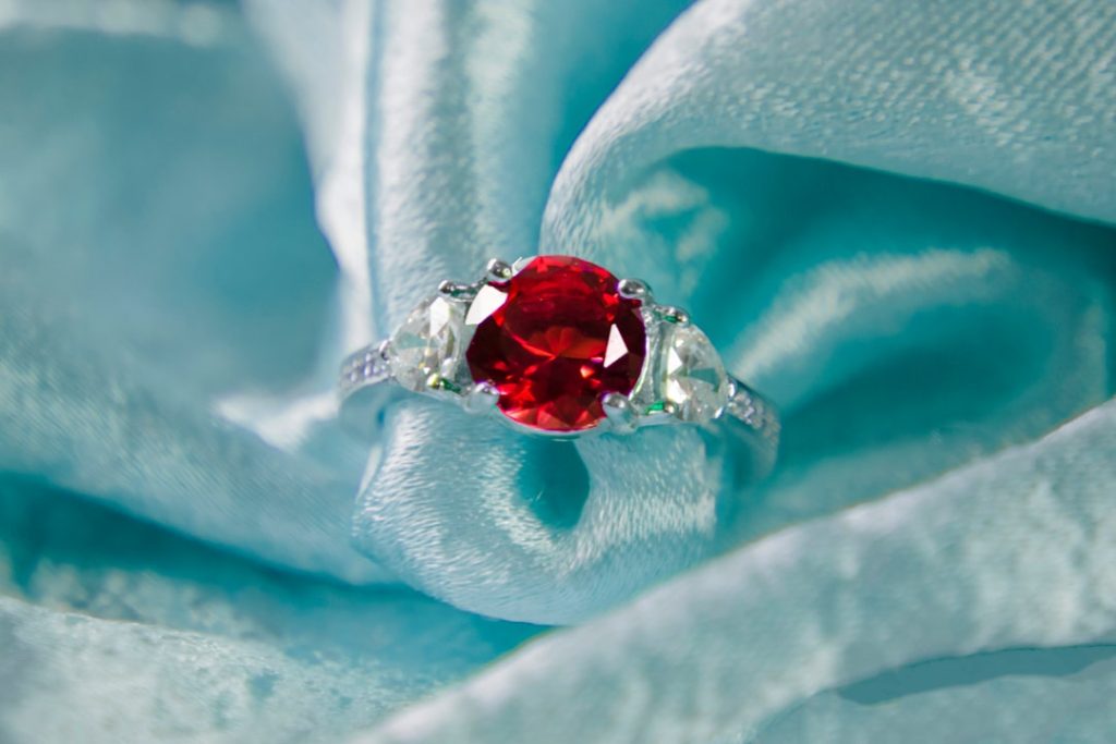 A ruby and diamond ring on blue silk