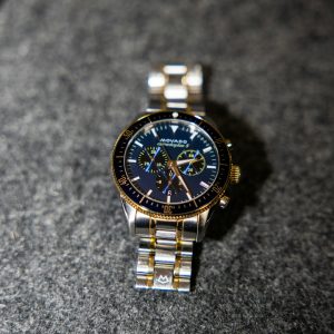 A close-up of a gold and silver watch