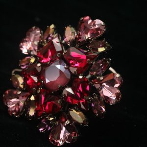 A cluster of sparkling red and pink rhinestones