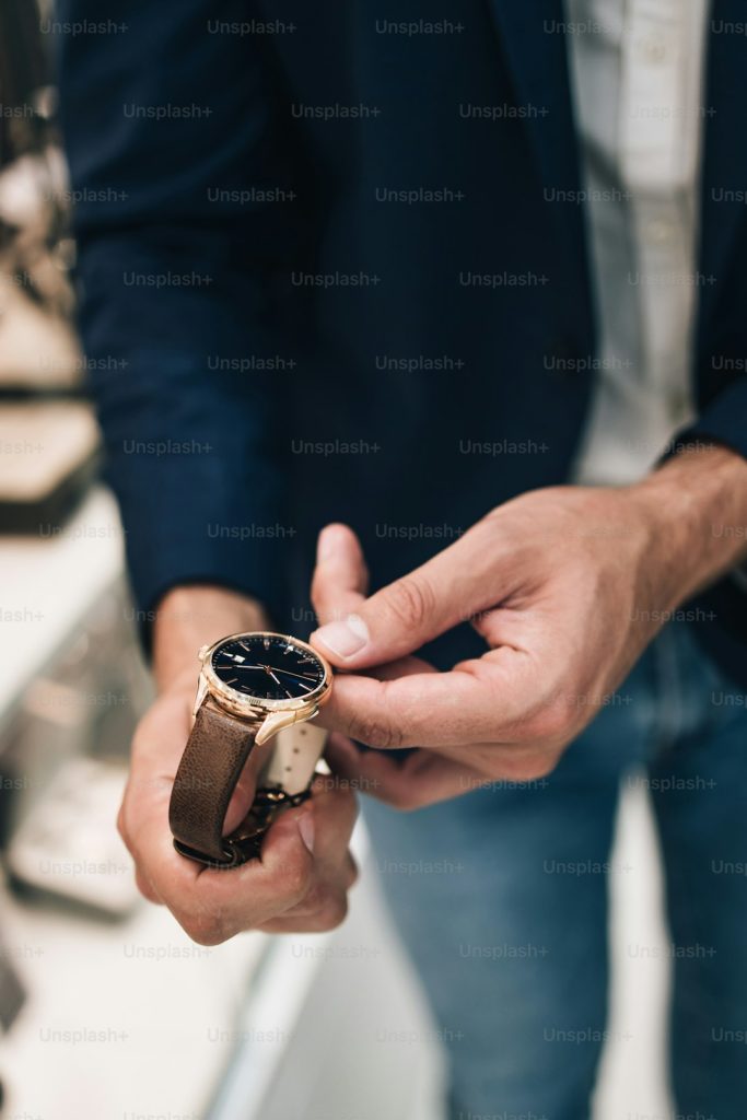 Beautiful couple enjoying in shopping at modern jewelry store while trying out and buying watches.