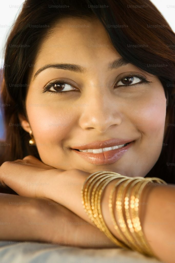 a close up of a woman with bracelets on her arm