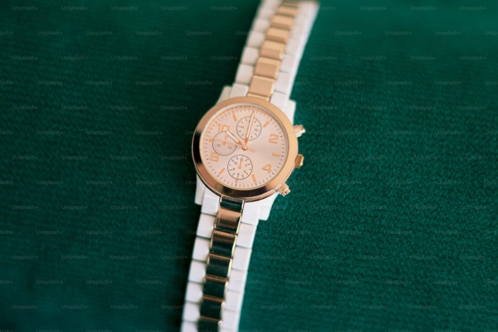 A watch sitting on top of a green cloth
