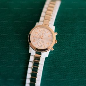 A watch sitting on top of a green cloth