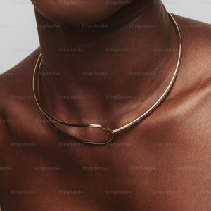 Woman wearing a delicate gold choker necklace